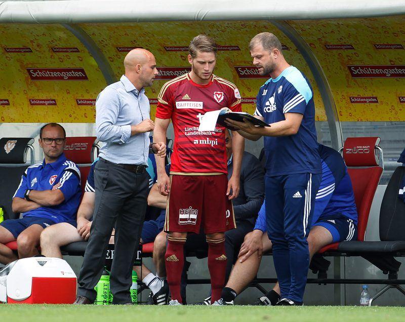 Der Vaduzer Nicolas Hasler, Mitte, kurz vor seiner Einwechslung im Gespraech mit Trainer Giorgio Contini, links, und seinem Assistenten Daniel Hasler, rechts, aufgenommen am Sonntag, 26. Juli 2015, beim Fussball Super-League Spiel zwischen dem FC Vaduz gegen den FC Zuerich im Vaduzer Rheinpark Stadion. Foto & Copyright: Eddy Risch.